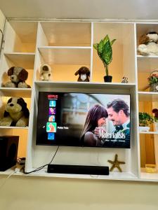 a television in a white cabinet with a tv screen at Polea Tatu in Ngong