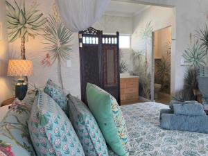 a bedroom with a bed with blue pillows at McGregor Hideaways in McGregor