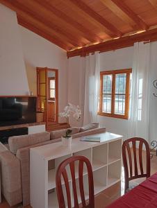 a living room with a couch and a table and chairs at Cozy Chalet with Sea Views & Private Pool in Valldemossa