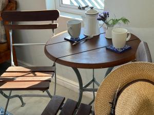a wooden table with two cups and flowers on it at McGregor Hideaways in McGregor