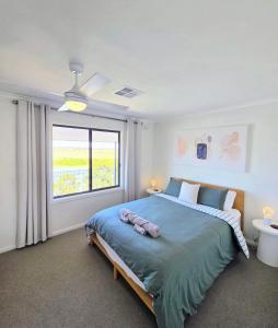 a bedroom with a large bed and a window at RiverBed Rise in Tailem Bend