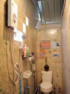 a small bathroom with a toilet and a shower at chananthida suyarach in Ban Mai Na Hi +16 photos