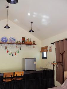 a kitchen with a counter with a tv on the wall at chananthida suyarach in Ban Mai Na Hi
