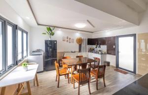 a kitchen and dining room with a table and chairs at Hamilton Villa Da Lat - Pine Tree n Valley View in Khu Chi Lăng