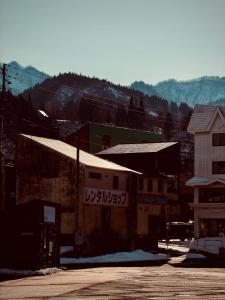a small town with a building and a mountain at Yuzawa Hotel New Fukudaya-ski in ski out in Minami Uonuma