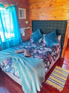 a bedroom with a bed with blue pillows at Serendipity Guest Farm Byrne in Byrne +72 photos