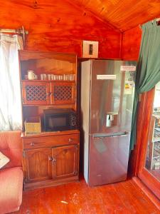 a refrigerator in a room with a wooden ceiling at Serendipity Guest Farm Byrne in Byrne
