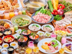 a table topped with lots of different types of food at Ala Mahaina Condo Hotel in Motobu