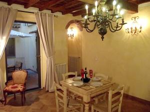 a dining room with a wooden table and a chandelier at Guelfa Patio Apartment in Florence
