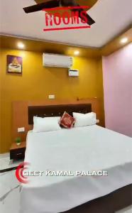 a hotel room with a bed with a sign on the wall at GeetKamal Palace Ayodhya Dham in Ayodhya