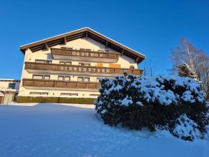 a building with snow in front of it at Gasthof Siebenstern in Röslau