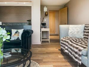 a living room with a couch and a glass table at The Foxes Hole - Uk49085 in Winewall