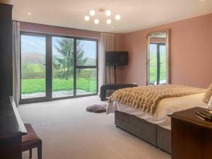 a bedroom with a bed and a large window at The Foxes Hole - Uk49085 in Winewall