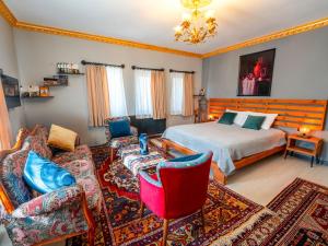 a living room with a bed and a couch at Alpha Stone House in Göreme