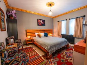 a bedroom with a bed and a living room at Alpha Stone House in Göreme +60 photos