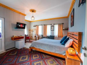 a bedroom with a bed and a tv in it at Alpha Stone House in Göreme