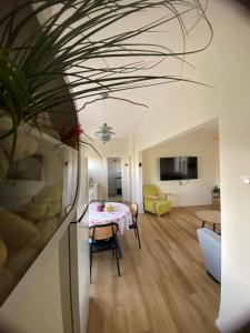 a living room with a table and a couch at Rivers view in kibbutz Dafna in Dafna