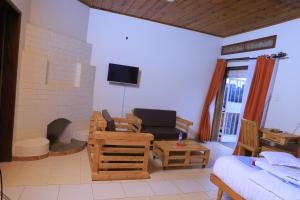 a living room with a couch and a fireplace at Hakyiri B&B in Kabale