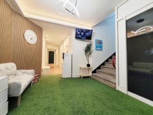 a living room with a couch and green carpet at 부천역 감성 숙소 in Samgong