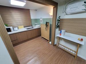 a kitchen with a counter and a sink and a table at 부천역 감성 숙소 in Samgong +10 photos