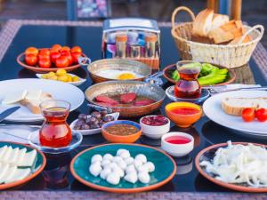a table full of food on a table with plates of food at Alpha Stone House in Göreme