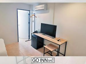 a room with a desk with a computer on it at xx GO INN Phuket Old Town in Phuket