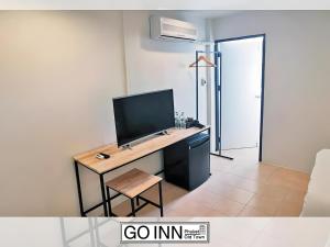 a room with a desk with a computer on it at xx GO INN Phuket Old Town in Phuket +16 photos