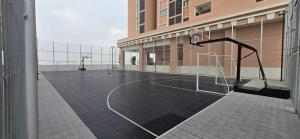 an empty basketball court in a building with a net at Setia Alam Homestay - Quiet High-Floor Studio in Shah Alam
