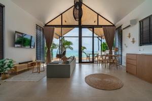 a living room with a view of the ocean at Sea Escapes Villas in Thong Sala