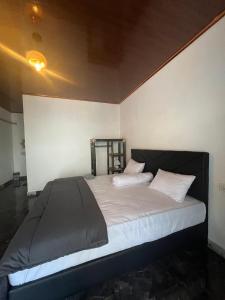 a bed with white sheets and pillows in a room at Andre Homestay in Kuta Lombok +18 photos