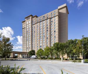 a large building with a parking lot in front of it at Hyatt Regency Wichita in Wichita