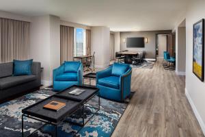a living room with blue chairs and a table at Hyatt Regency Wichita in Wichita
