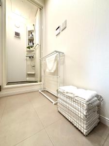 a bathroom with a towel rack and a mirror at Hal Kokubunji in Kokubunji