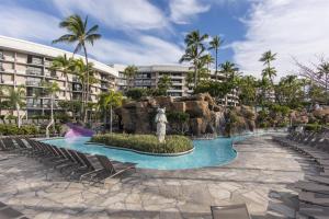 a resort with a pool and a water slide at Hilton Grand Vacations Club Ocean Tower Waikoloa Village in Waikoloa