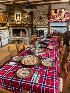 a table with a red and blue plaid table cloth at Villa Martina in Smilyan