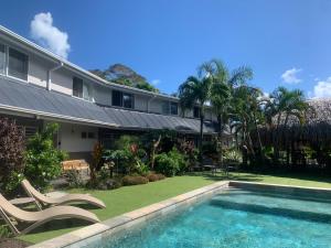 an exterior view of a house with a swimming pool at Tiki Ora Lodge - TIKI in Bora Bora
