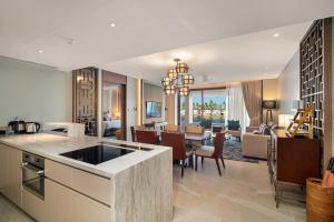 an open kitchen and living room with a dining room at Angsana Oceanview Residences Building 2 in Laguna by Banyan Living in Bang Tao Beach