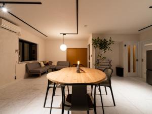 a dining room and living room with a table and chairs at The THERM in Munakata +52 photos