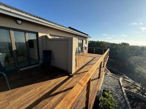 a wooden deck on a house with a view at Seenekal views in Cannon Rocks