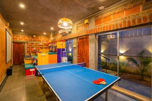 a ping pong table in a room at goSTOPS Pondicherry Near Auroville in Auroville