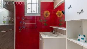 a bathroom with a sink and a red wall at CHEZ BETTY in Le Luc +13 photos