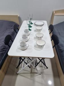 a white table with bowls and glasses on it at ValueStay Hotel 9A in Seoul