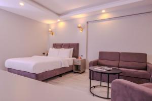 a hotel room with a bed and a couch at Rubby Kadıköy in Istanbul