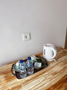 a tray with bottles of water on a table at Willy Homestay in Uluwatu
