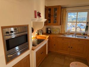 a kitchen with a sink and a microwave at Apartment Sonnenhang in Wallgau