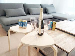 a bottle of champagne and two tables with glasses at Itoshima Private Villa 4LDK 4-Bedroom in Itoshima