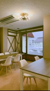a conference room with chairs and tables and a window at Yuzawa Hotel New Fukudaya-ski in ski out in Minami Uonuma