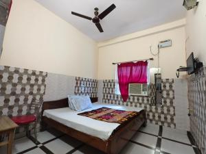 a small bedroom with a bed and a window at Hotel Vijay in Rājgīr +39 photos