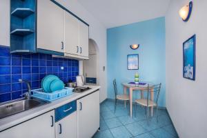 a kitchen with a sink and a table at Samson΄s Village in Perissa