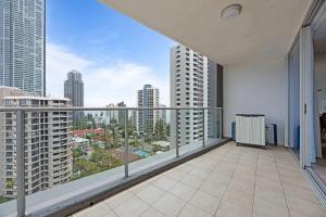 an apartment balcony with a view of the city at Stylish Beachside Retreat in Gold Coast +12 photos